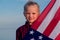 Blonde girl waving national USA flag outdoors over blue sky at summer - american flag, country, patriotism, independence