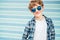 Blonde hair 12 year old caucasian teenager boy Fashion portrait dressed white t-shirt with checkered shirt in blue sunglasses with