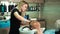 Blonde hair stylist washes the head with shampoo men who came to beauty salon