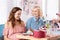 Blonde-haired caring friend visiting baby shower of her colleague