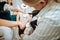 Blonde-haired chiropodist holding foot of her client making pedicure