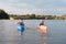 Blonde-haired man looking at his lovely girlfriend while kayaking