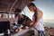 Blonde-haired man with tattoo making morning porridge for his woman