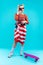 Blonde-haired woman with flag over her waist making photo