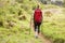 Blonde hiker hiking with trekking poles