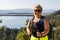 Blonde hiker woman poses at Inspiration Point in Grand Teton National Park, overlooking Jenny Lake