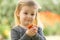 Blonde Little Girl Holding a Flower