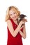 Blonde little girl holding puppy wearing red dress
