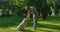 Blonde man petting golden retriever. Concentrated dog sit look aside in park