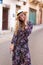 Blonde Mediterranean woman floral pattern dress posing