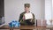 A blonde in a military uniform holds gifts in her hands. The surprise is inside the box.