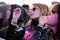 Blonde modern girl with extravagant pink sunglasses and a heart drawn on her hand, watch a concert at Heineken Primavera Sound