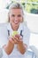 Blonde nurse holding a green apple