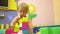Blonde preschool toddler playing with multi coloured building blocks in nursery school. Child development in
