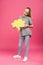 blonde preteen child holding yellow thought bubble, isolated