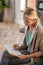 Blonde psychoanalyst wearing stylish cardigan making notes