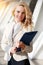 Blonde smiling lady in stylish suit. Successful business worker concept