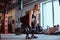 Blonde sportive female in sportswear doing deadlift with barbell in the fitness club or gym.