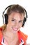 Blonde sporty woman listening music in headphones on white background