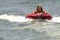 Blonde teenager being pulled on a inner tube raft