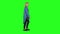 Blonde teenager girl calmly walking on green screen background. Chroma key, 4k shot. Profile view.