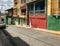 Blonde travels in the street with colored houses in Santiago de Cuba