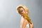 Blonde in white dress holding golden calla lilly