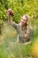 Blonde winegrower handing a red grape