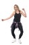 Blonde woman aerobics instructor dancing jazz dance passionately while looking down.