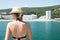 Blonde woman against the backdrop of the sandy beach of the Black Sea resort