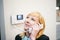 Blonde woman answers the intercom call