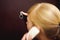 Blonde woman answers intercom call, hold the phone to his ear