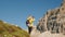 A blonde woman captures the mountain landscapes of the Italian Alps near Tre Cime di Lavaredo