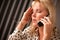 Blonde Woman on Cell Phone with Stressed Look