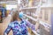 Blonde woman chooses alcohol or wine at a supermarket.