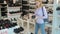 Blonde woman chooses shoes in a shoe boutique