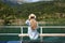Blonde woman enjoying mountain view on a ferry