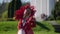 blonde woman in fantasy red dress is walking in garden, red queen, medieval dame