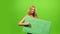 blonde woman on green screen, blank sign