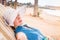 Blonde woman has rest on the beach on the sunbed