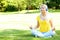 Blonde Woman with Headphone Meditating Outdoor