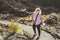 Blonde woman hiker along the trail in Lava Lands - Newberry Crater National Monument in Oregon