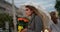 Blonde woman holding a bunch of roses