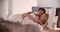 Blonde woman and man smiling, hugging and sleeping. Couple in love morning wake up at home in bedroom. Caucasian
