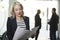 Blonde woman in office looking papers