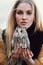 Blonde woman with an owl in her hands walks in the woods in autumn and spring. Long hair girl, romantic portrait with owl