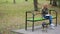 Blonde Woman in a park feeding a stray mongrel dog