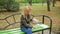 Blonde Woman in a park feeding a stray mongrel dog