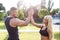 Blonde woman with personal trainer give high five