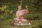 Blonde woman in a pink kimono playing on meditative Himalayan Tibetan music